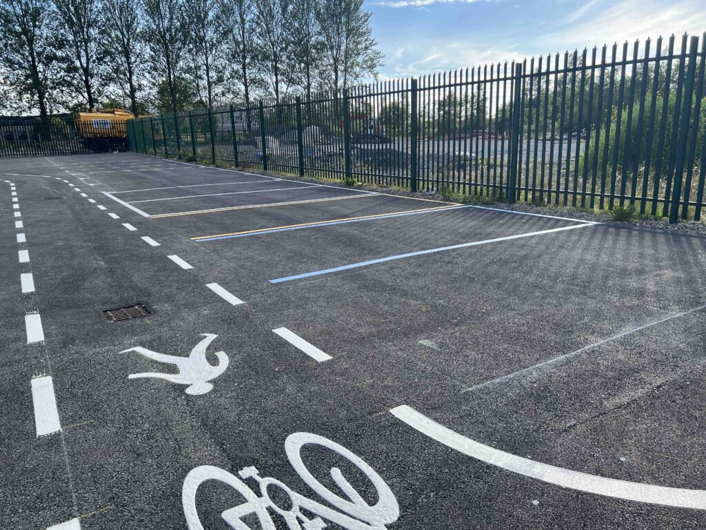 Dedicated pedestrian and bicycle lane markings beside parking spaces at FMCI’s proving ground, supporting research in micro-mobility, road safety, and shared transport infrastructure for connected and autonomous vehicles.