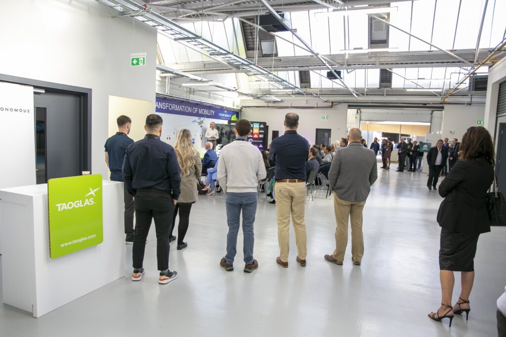 Audience standing and observing presentation